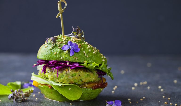 Avocado sandwich with green vegan burger,  roast yellow pepper and pickled red cabbage